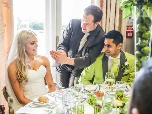 Magician performing for bride and groom at wedding table